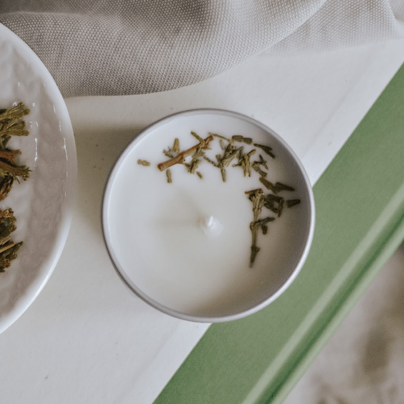 Mother Earth Essentials Cedar Balsam candle shown in a winter home scene